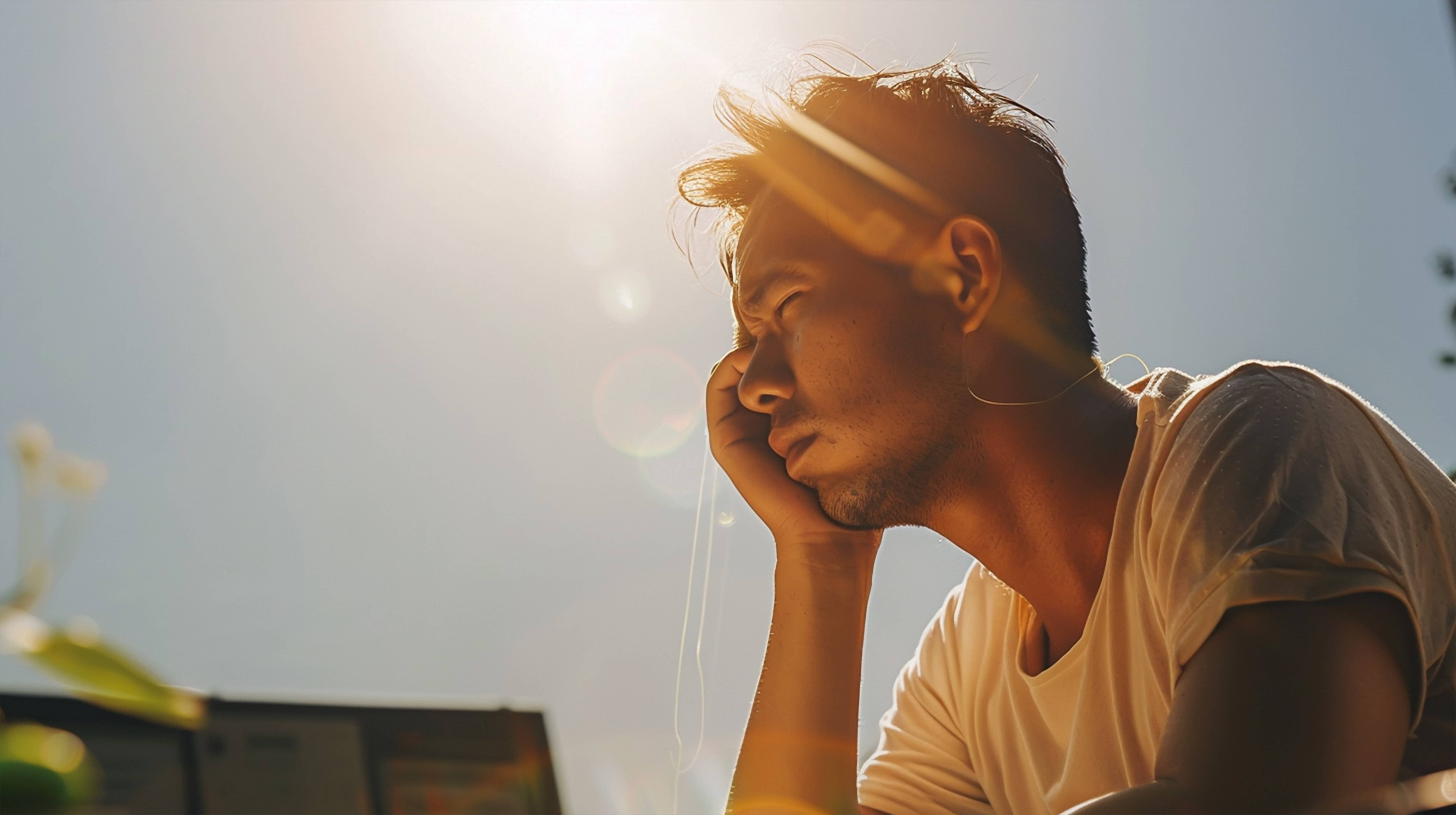 A person showing early signs of heatstroke, looking dizzy.