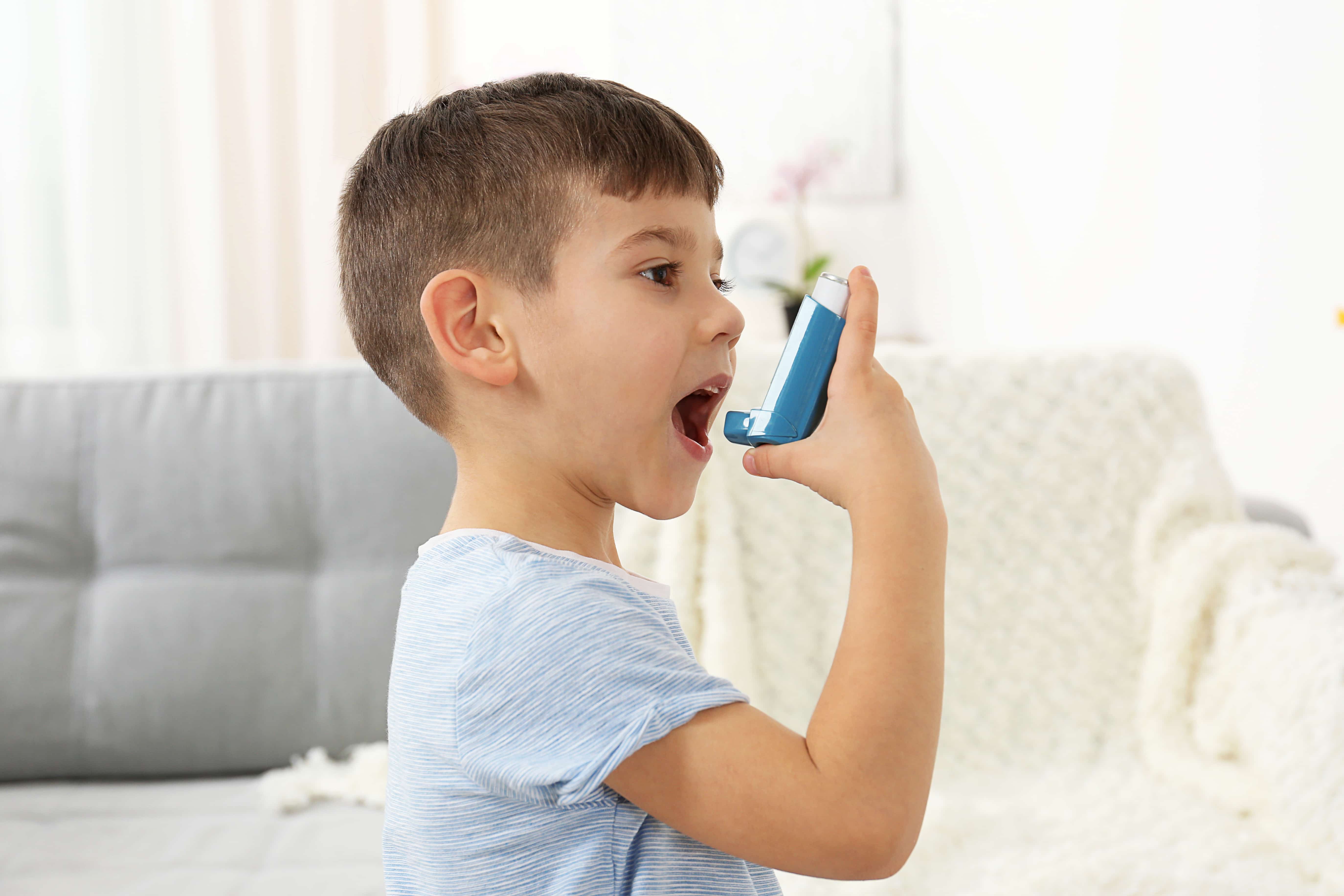 Child using an asthma inhaler for respiratory relief while traveling in Japan