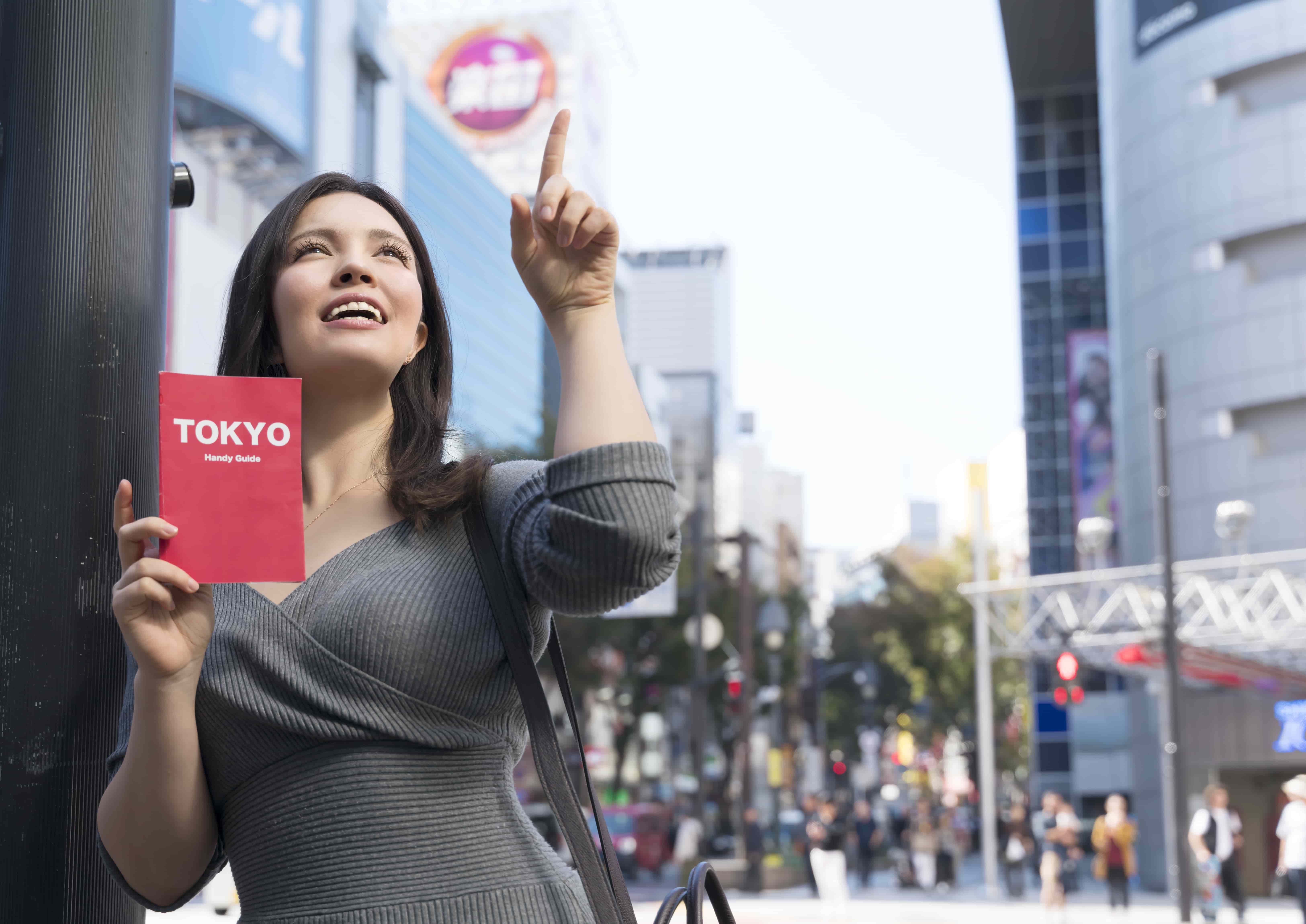 Two people in traditional Japanese clothing sitting on wooden floor looking at garden