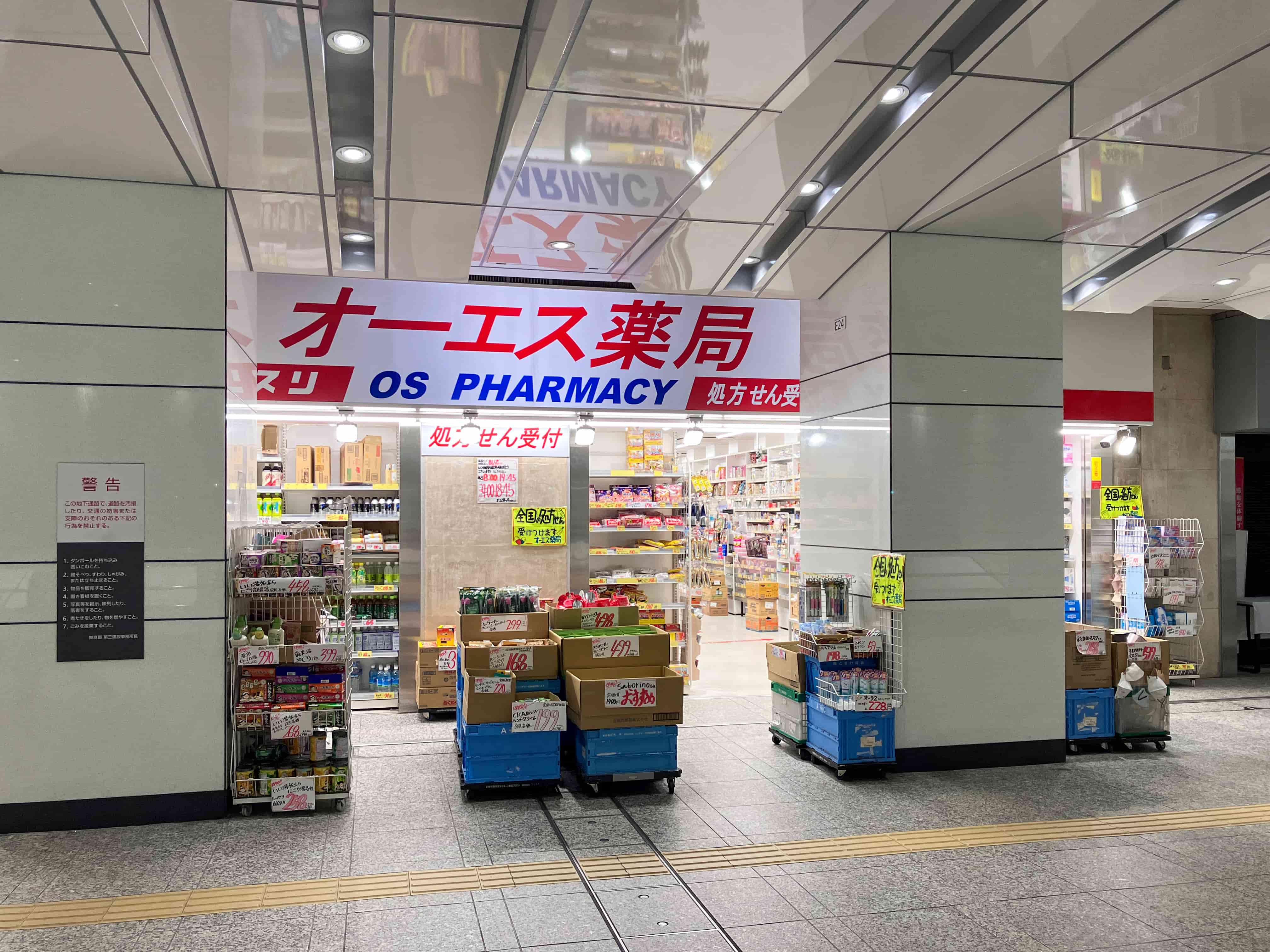 Pharmacist holding prescription medicine and papers at pharmacy counter