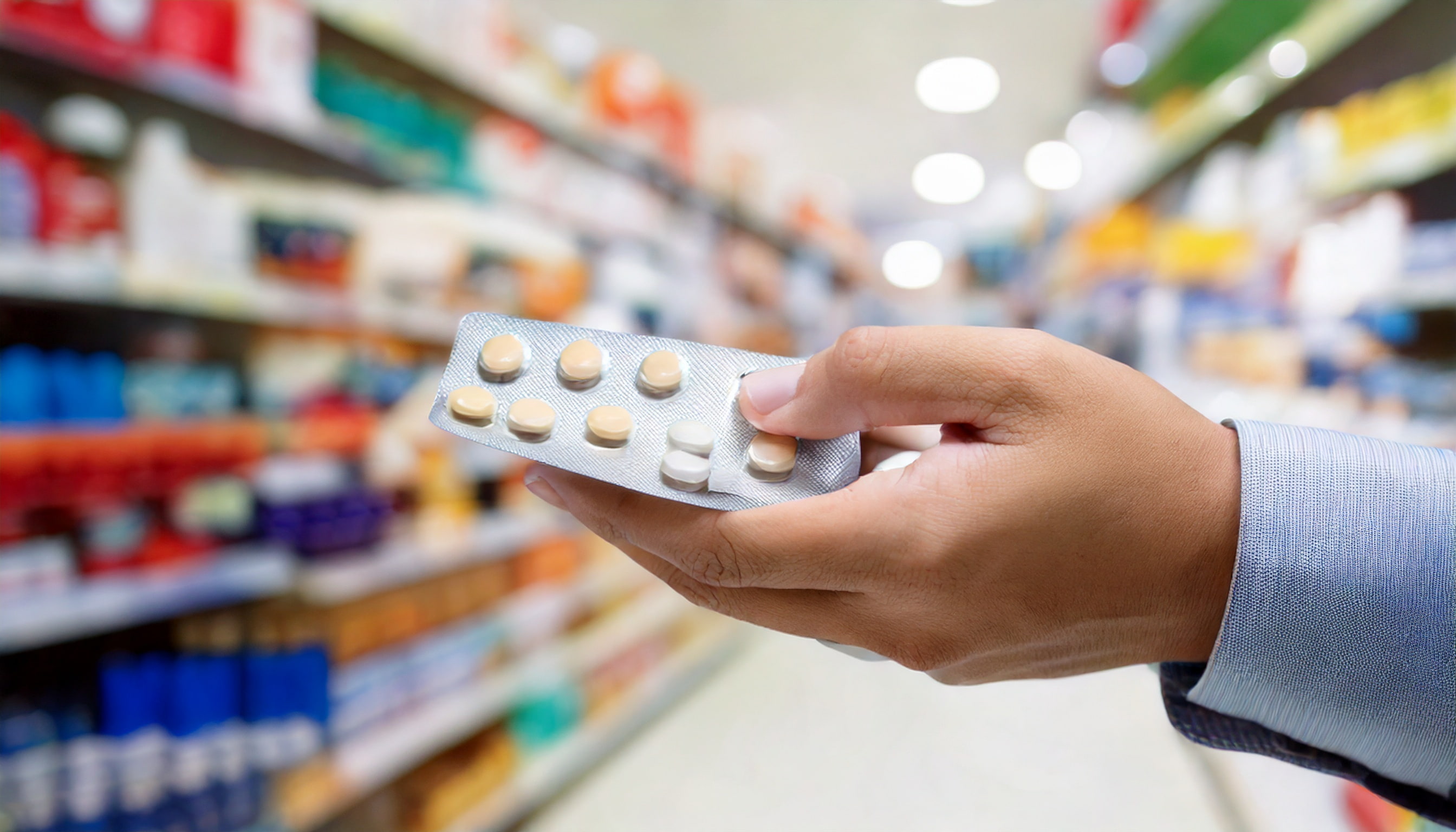 Tourist consulting with Japanese pharmacist using translation app for medicine recommendations