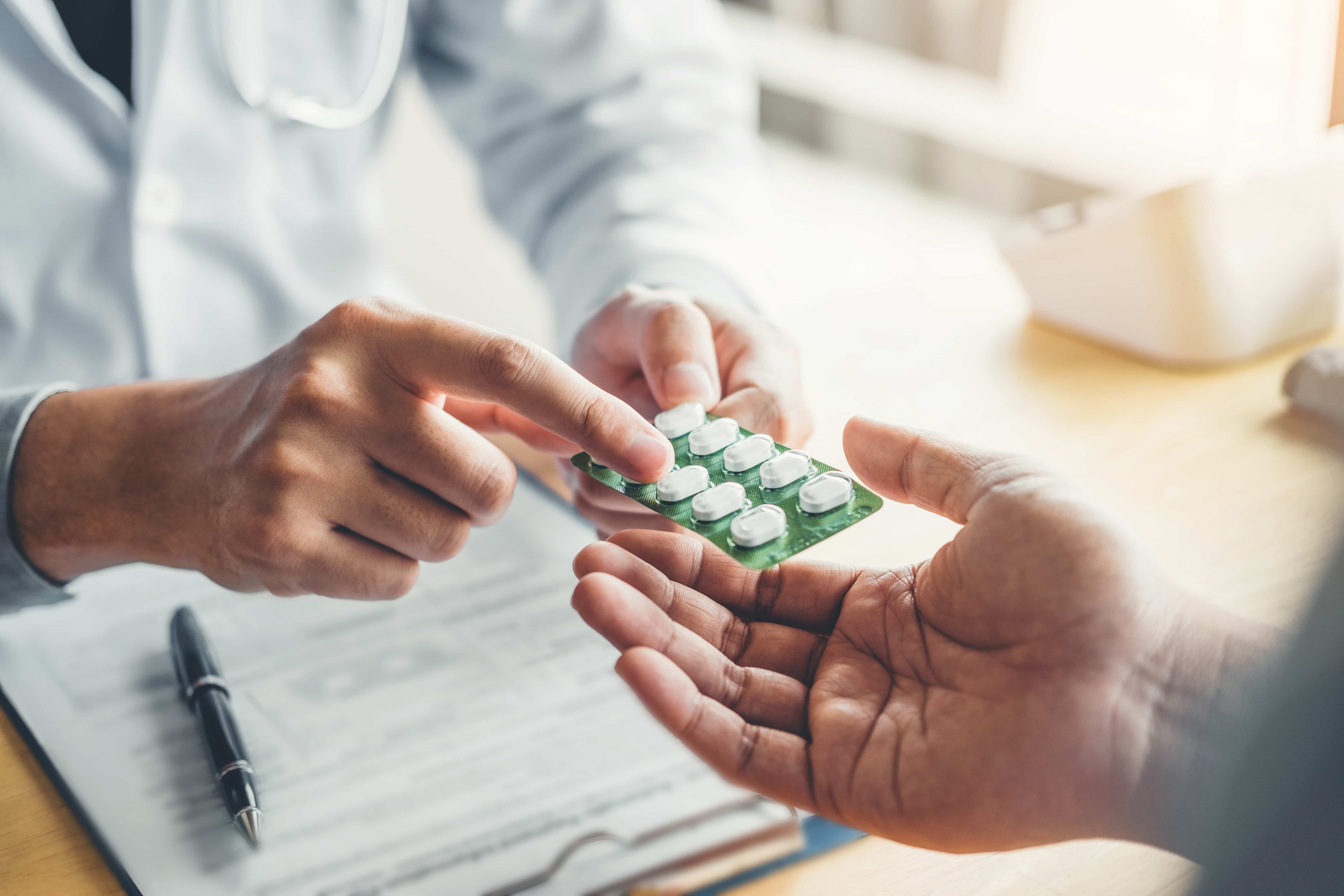 Pharmacist in Japan explaining antiviral medication to a patient